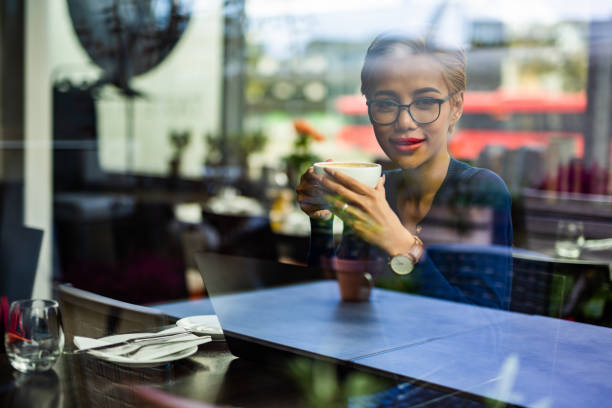 istock Young asian female student drinking cappucino in restaurant. 1042400620