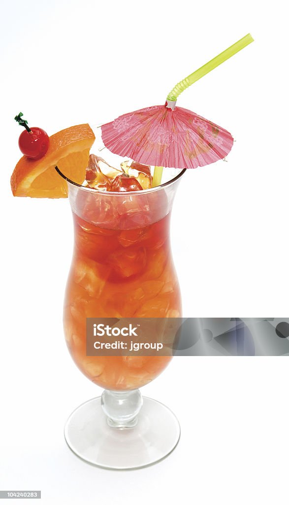 Tropical cocktail in a glass with an umbrella Tropical drink in a hurricane glass with orange slice, cherry and a paper umbrella Mai Tai Stock Photo