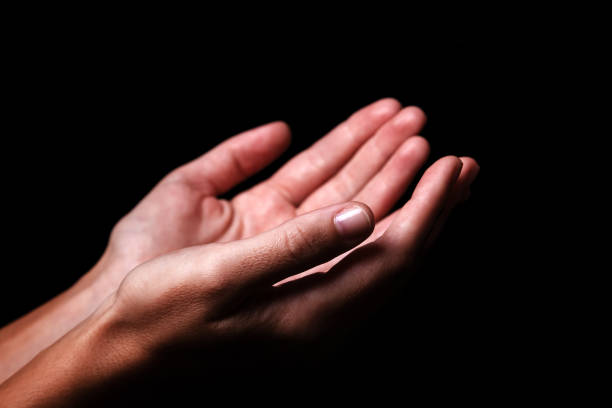 istock Female hands praying with palms up arms outstretched. 1042404182