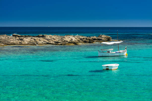 istock Fishing boats and rocks 1042408126