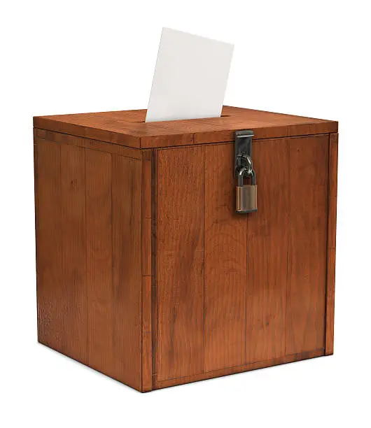 An envelope going in the slot of a ballot box