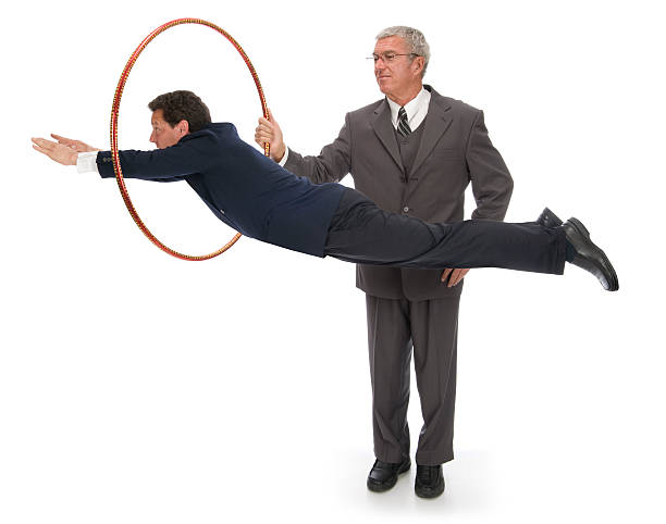 Man in a suit jumping through hoops