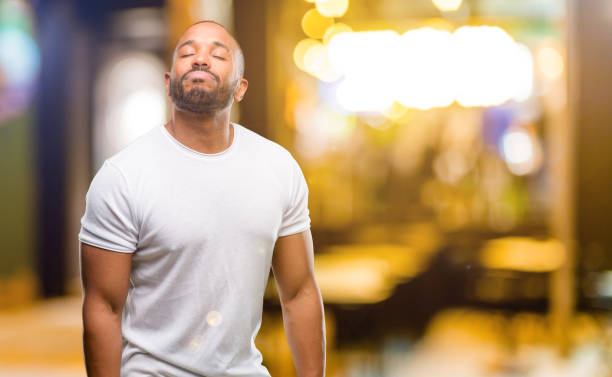 istock African american man with beard with sleepy expression, being overworked and tired 1042411812