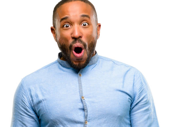 istock African american man with beard happy and surprised cheering expressing wow gesture 1042412010