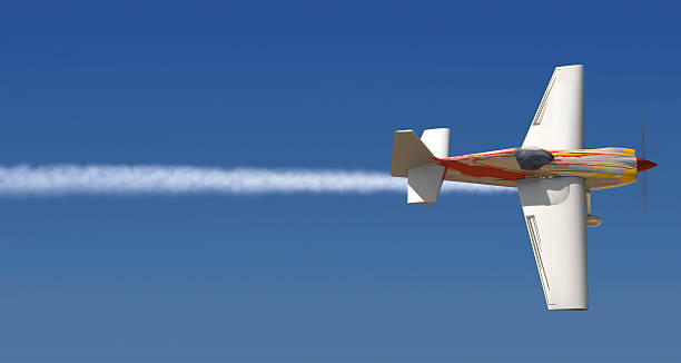A small plane in mid flight writing a line through the sky Single engine plane in the sky with a trail of smoke following it words in the sky stock pictures, royalty-free photos & images