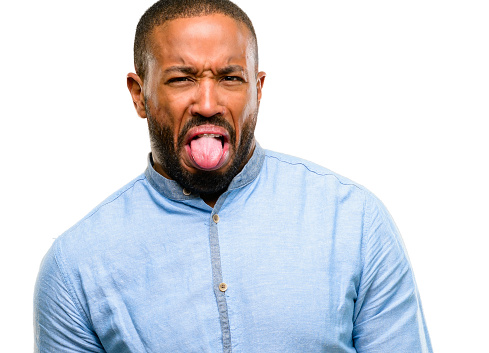 African american man with beard feeling disgusted with tongue out isolated over white background
