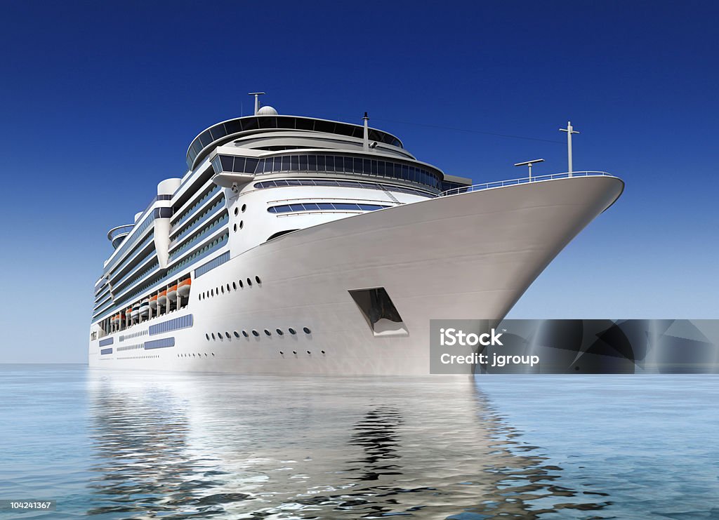 cruise ship luxury white cruise ship shot at angle at water level on a clear day. Cruise Ship Stock Photo