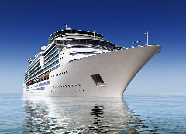 cruise ship luxury white cruise ship shot at angle at water level on a clear day. passenger craft photos stock pictures, royalty-free photos & images