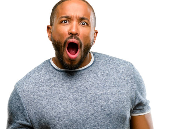 istock African american man with beard scared and surprised cheering expressing wow gesture. Unbelieving 1042414374