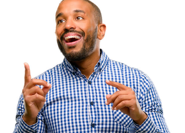 istock African american man with beard happy and surprised cheering pointing up 1042414592