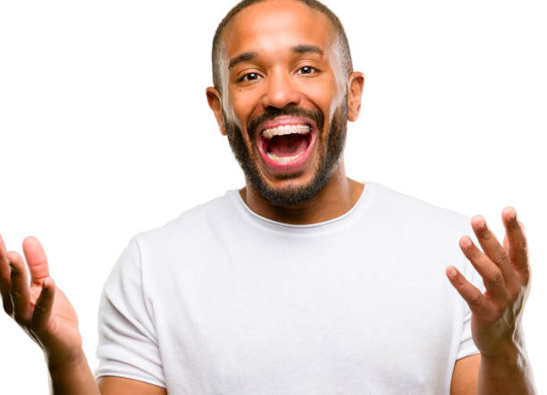 istock African american man with beard happy and surprised cheering expressing wow gesture 1042415466