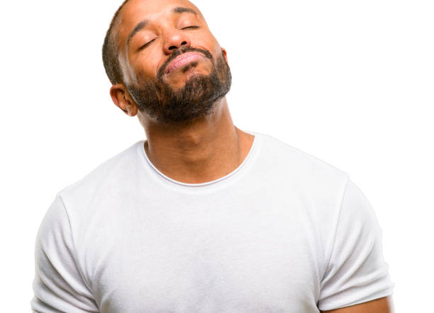istock African american man with beard with sleepy expression, being overworked and tired 1042415510