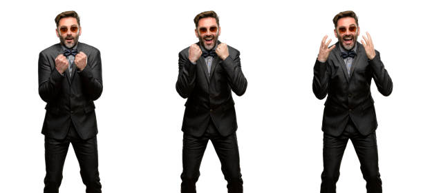 istock Middle age man, with beard and bow tie happy and surprised cheering expressing wow gesture 1042416438