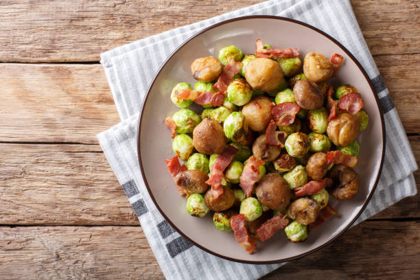 istock Fried chestnuts, brussels sprouts and bacon closeup. horizontal top view 1042419456