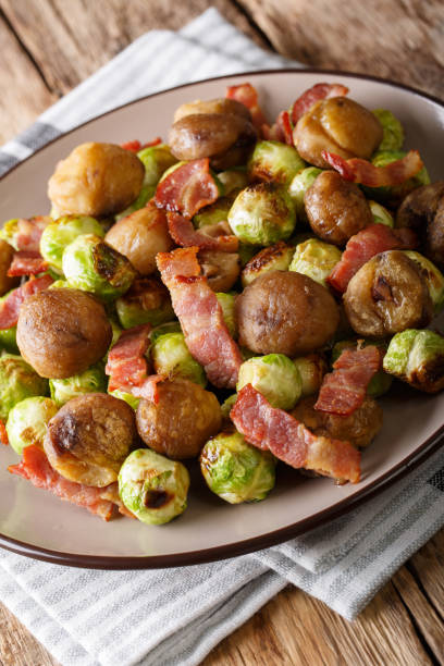 istock Fried chestnuts, brussels sprouts and bacon closeup. vertical 1042419606