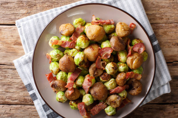 istock Delicious appetizer: roasted chestnuts, Brussels sprouts and bacon close-up. Horizontal top view 1042419646