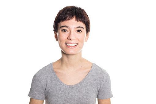 Portrait of happy woman looking at camera against white background. Female looking at camera confidently.