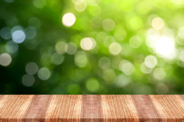 istock Wooden table top on green nature background 1042419928