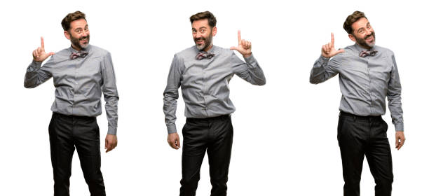 istock Middle age man, with beard and bow tie pointing away side with finger 1042420052