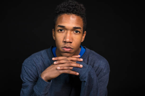 istock Serious young man with hand on chin 1042420160