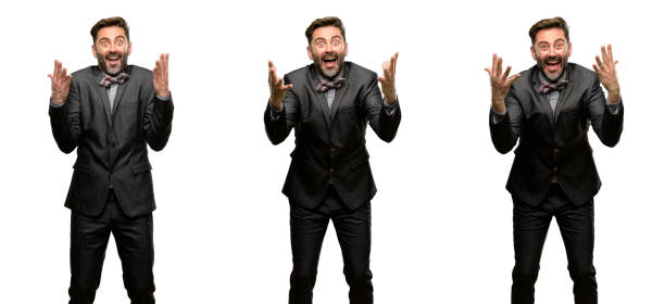 istock Middle age man, with beard and bow tie happy and surprised cheering expressing wow gesture 1042422336