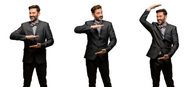 istock Middle age man, with beard and bow tie holding something, size concept 1042424384