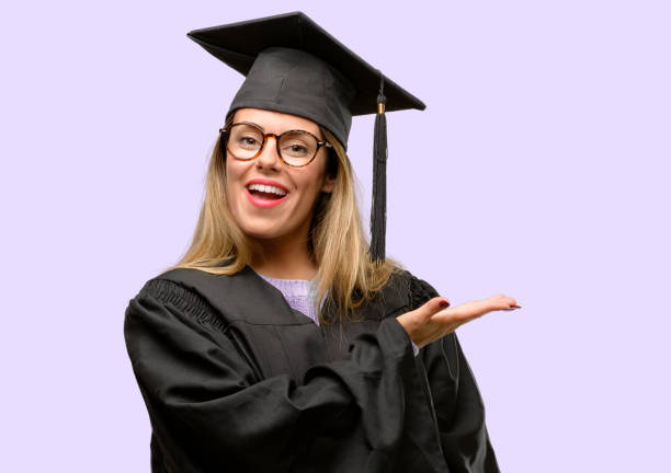 istock Young woman university graduate student holding something in empty hand 1042425240