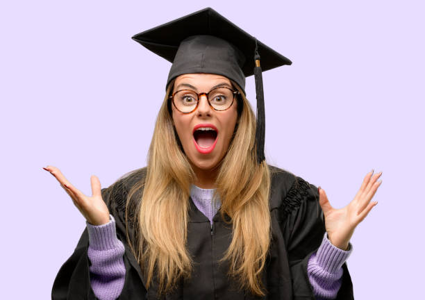 istock Young woman university graduate student happy and surprised cheering expressing wow gesture 1042425252