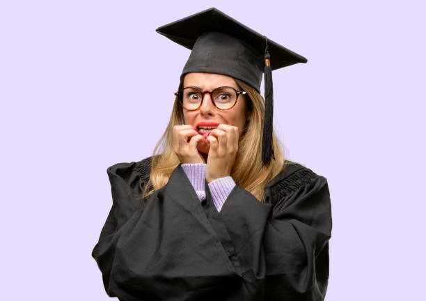 istock Young woman university graduate student terrified and nervous expressing anxiety and panic gesture, overwhelmed 1042425268