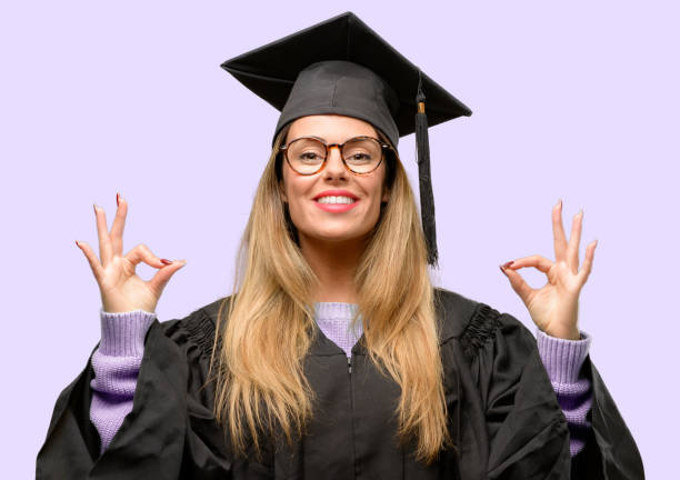 istock Young woman university graduate student doing ok sign gesture with both hands expressing meditation and relaxation 1042425270