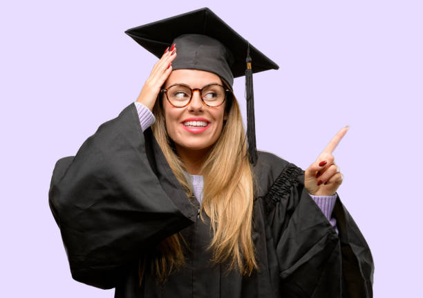istock Young woman university graduate student pointing away side with finger 1042425320