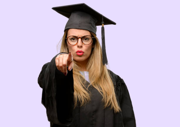 istock Young woman university graduate student pointing to the front with finger 1042425354