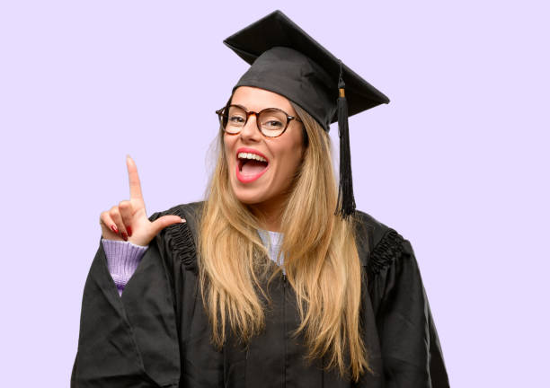 istock Young woman university graduate student pointing away side with finger 1042425376