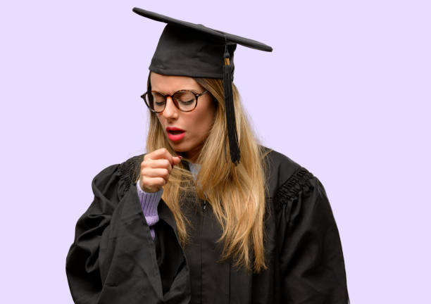 istock Young woman university graduate student sick and coughing, suffering asthma or bronchitis, medicine concept 1042425404