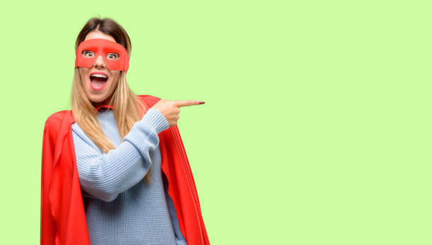 istock Young super woman pointing away side with finger 1042425456