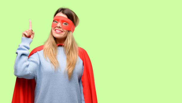 istock Young super woman happy and surprised cheering expressing wow gesture pointing up 1042425492