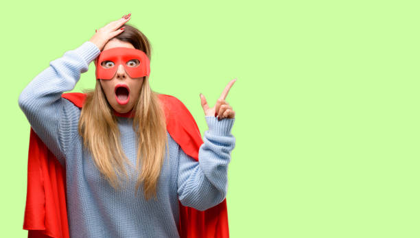 istock Young super woman pointing away side with finger 1042425542