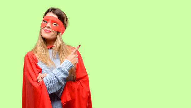 istock Young super woman pointing away side with finger 1042425604