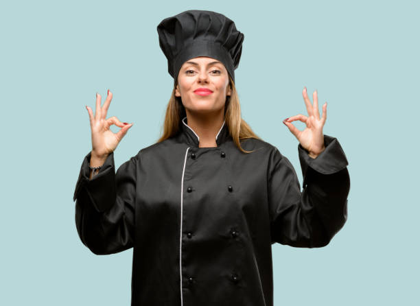 istock Young cook woman doing ok sign gesture with both hands expressing meditation and relaxation 1042425656