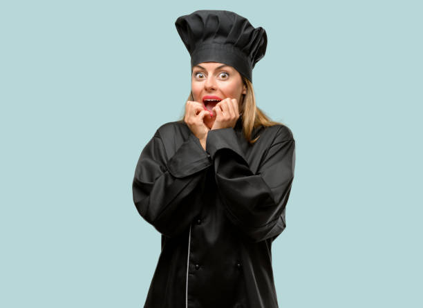 istock Young cook woman terrified and nervous expressing anxiety and panic gesture, overwhelmed 1042425662