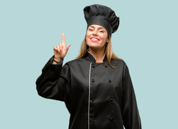 istock Young cook woman raising finger, the number one 1042425696