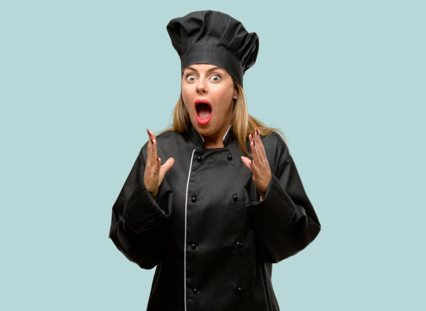 istock Young cook woman stressful keeping hands on head, terrified in panic, shouting 1042425722