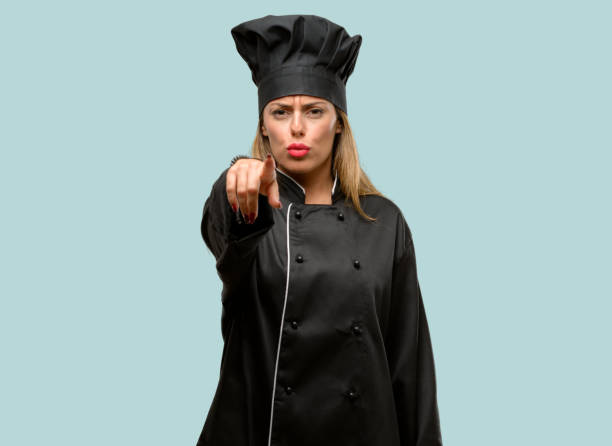 istock Young cook woman pointing to the front with finger 1042425764