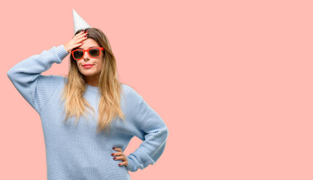 istock Young woman celebrates birthday doubt expression, confuse and wonder concept, uncertain future 1042426196