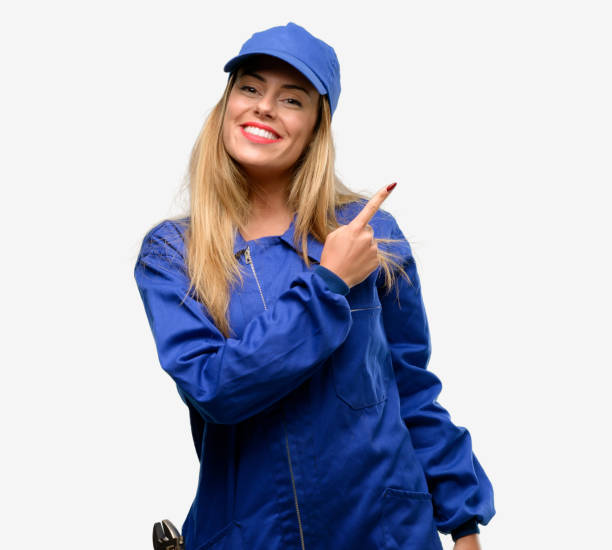 istock Young plumber woman pointing away side with finger 1042429492