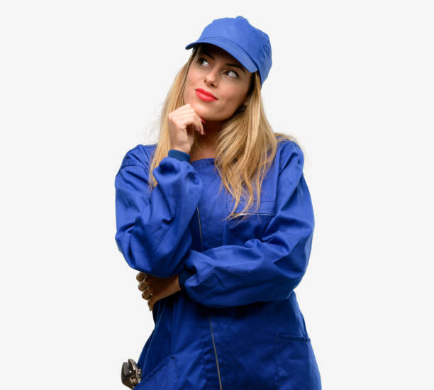 istock Young plumber woman thinking and looking up expressing doubt and wonder 1042429508