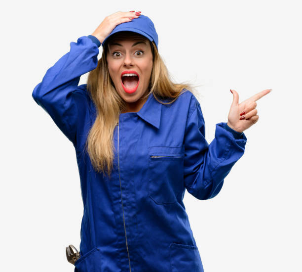 istock Young plumber woman pointing away side with finger 1042429582