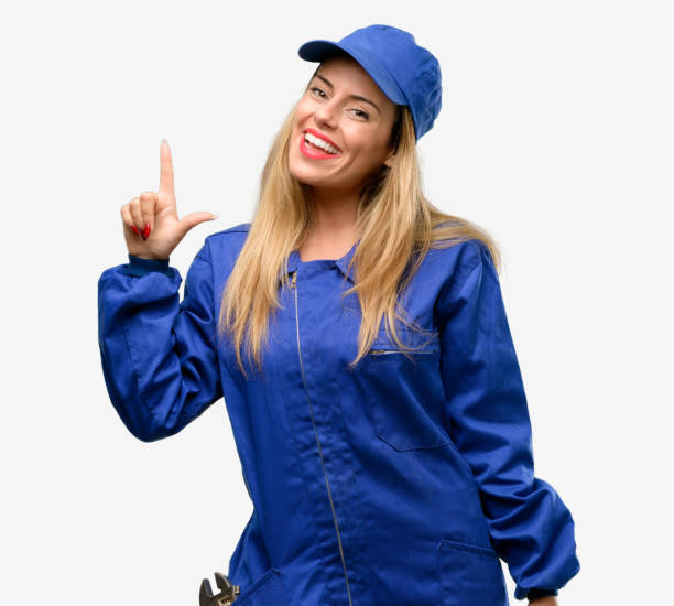 istock Young plumber woman pointing away side with finger 1042429642