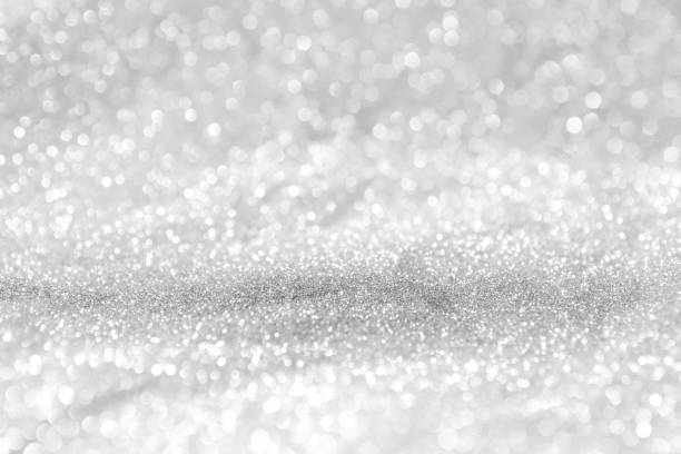 istock abstract background white Silver lights on christmas bokeh 1042430162