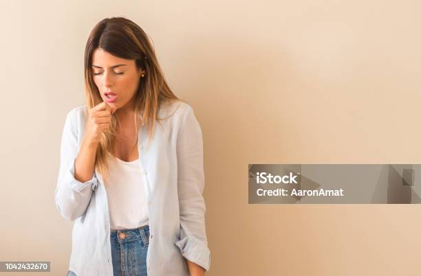 Vintage Photo Of A Beautiful Woman Against Wall Sick And Coughing Suffering Asthma Or Bronchitis Medicine Concept Stock Photo - Download Image Now